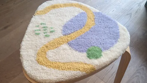 Cushioned stool on wooden floor.