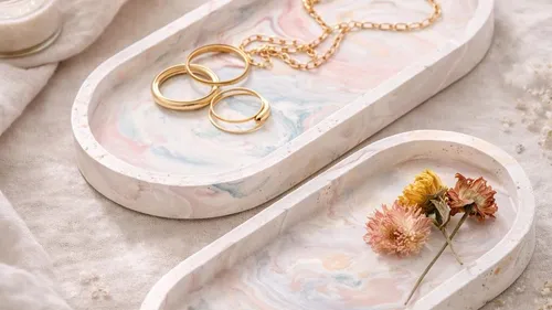 Jewelry and flowers on marble-patterned trays.