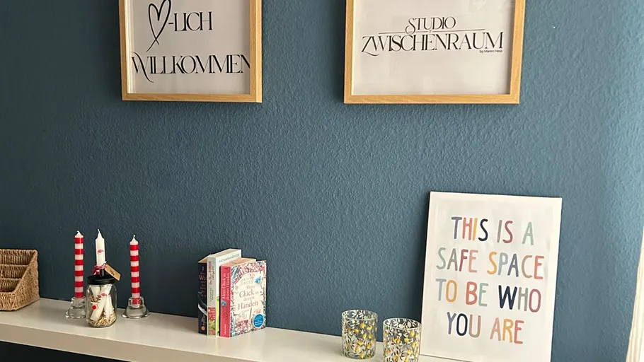 Decorated shelf with books and framed quotes.