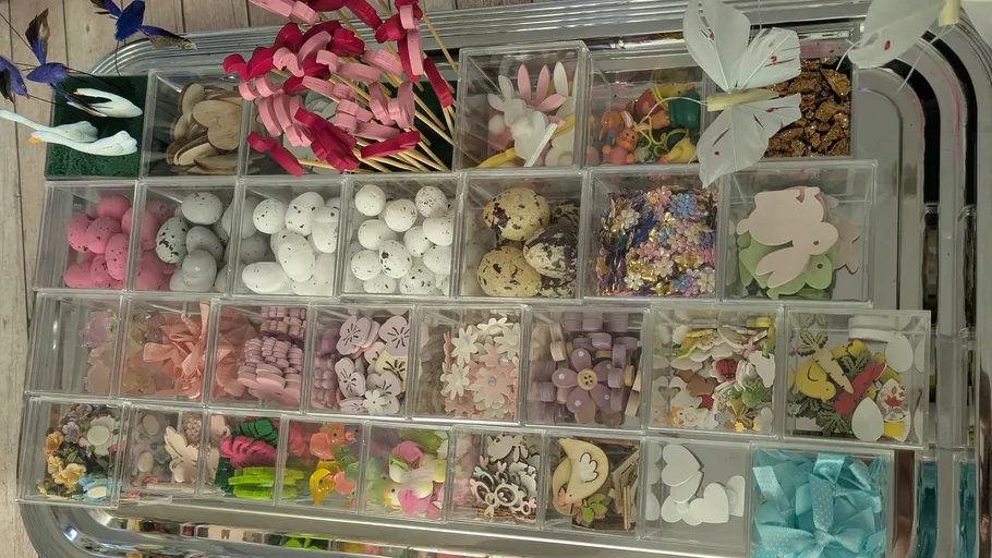 Craft supplies organized in clear compartments.