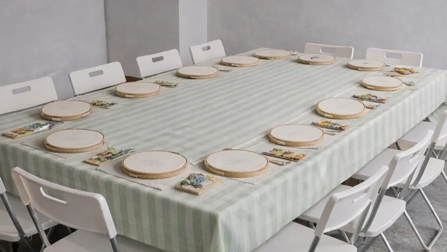 Stickrahmen auf einem Tisch mit Stühlen.