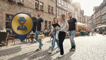 People walking in a cobblestone street.