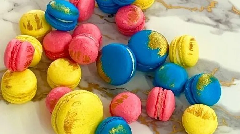 Colorful macarons on a marble surface.