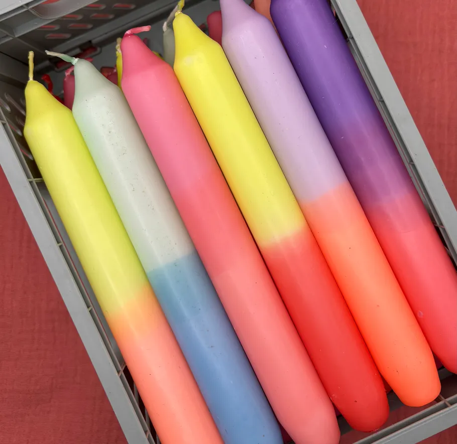 Colorful candles in a metal box.