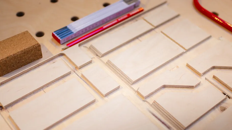 Wooden pieces with tools on a workbench.