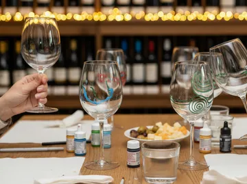 Decorated wine glasses on a table with paint.