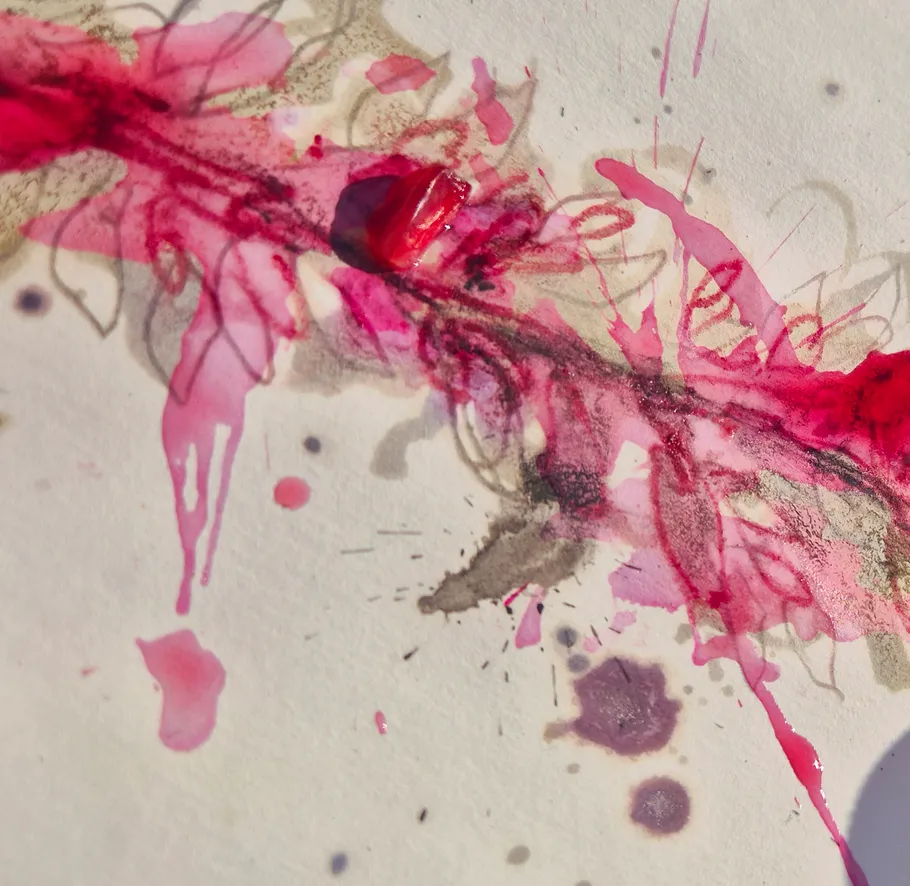 Abstract watercolor with pink and red splashes.