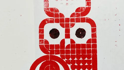 Red mosaic owl on white background.