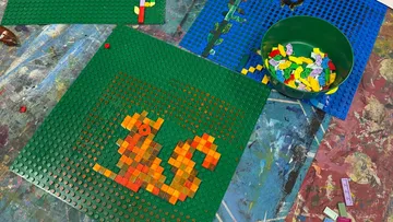 Lego squirrel built on a green baseplate.