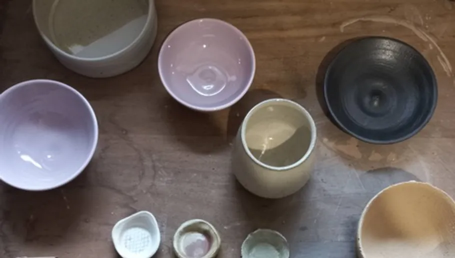 Assorted ceramic bowls on wooden table.