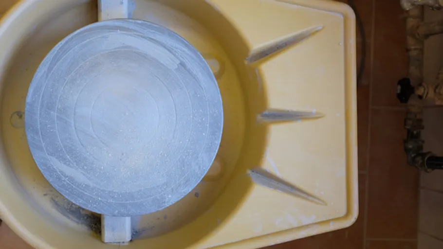 Potter's wheel with clay in studio.