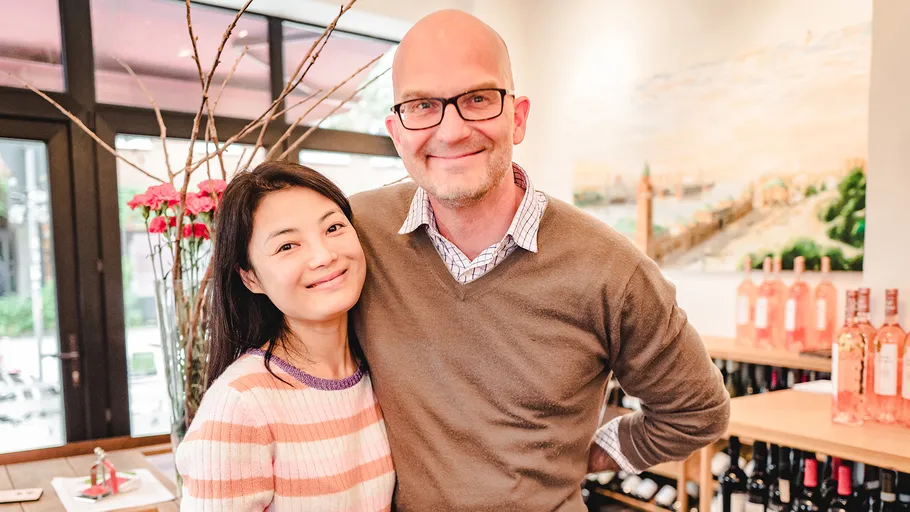 Two people smiling in a cozy shop.