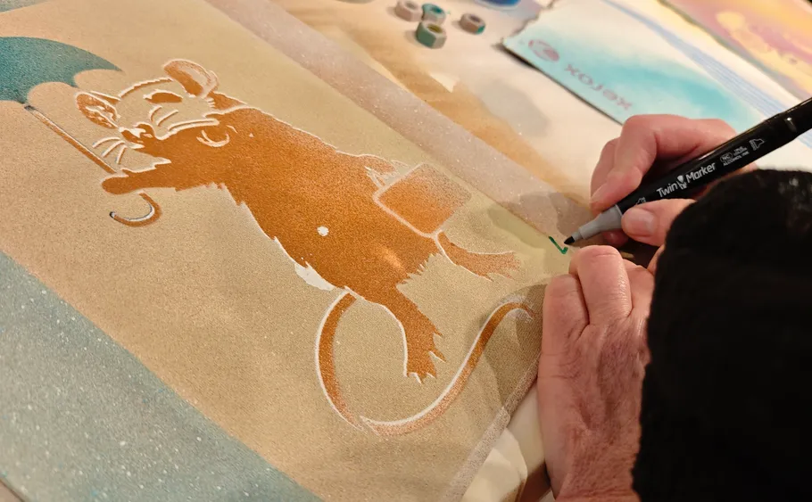 Person drawing cartoon mouse with marker art.