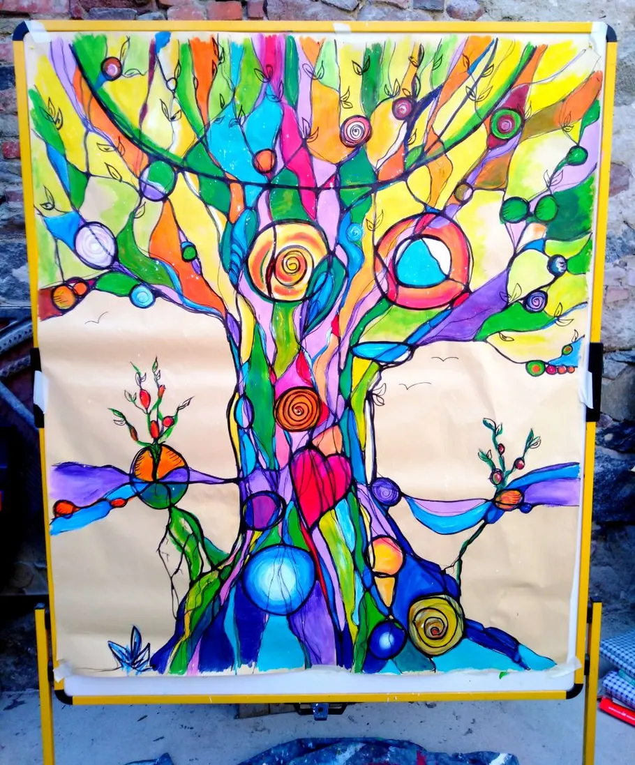 Colorful abstract tree painting on easel.