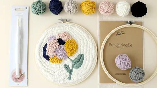 Punch needle project with yarn and needle.