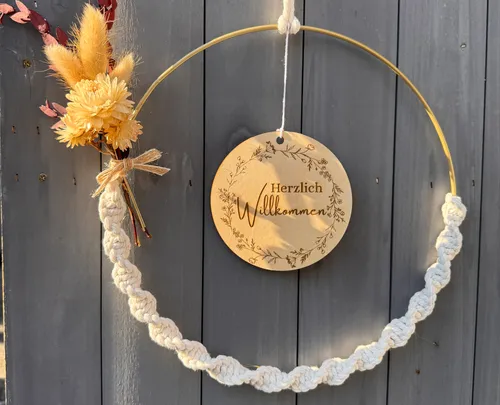 Wreath with flowers and welcome sign on door.