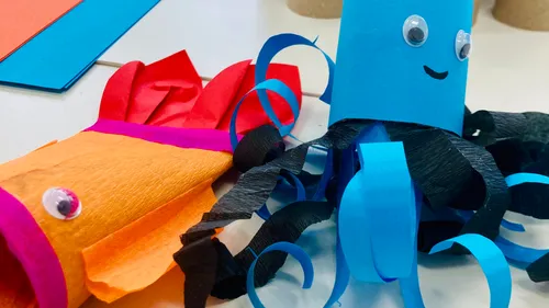 Paper sea creatures crafted on a table.