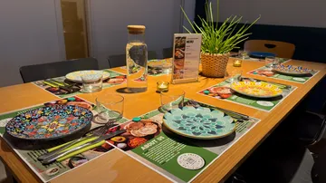 Colorful plates on a set dining table.