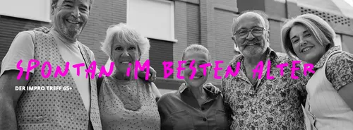 Group of five older adults smiling outdoors.