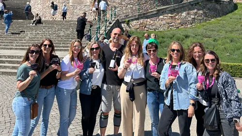 Group of people holding drinks outdoors.