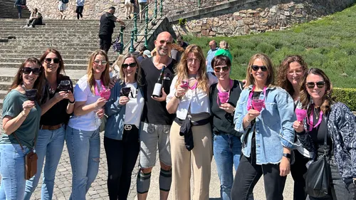 Group of people holding drinks outdoors.