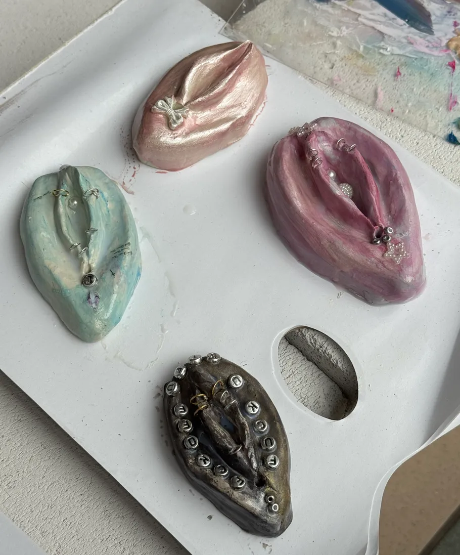 Four decorative sculptures on a white surface.