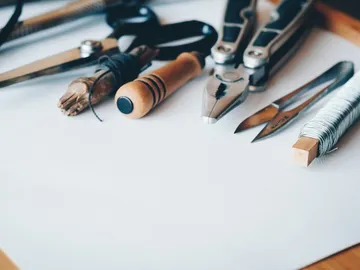 Tools lie on a white sheet of paper.