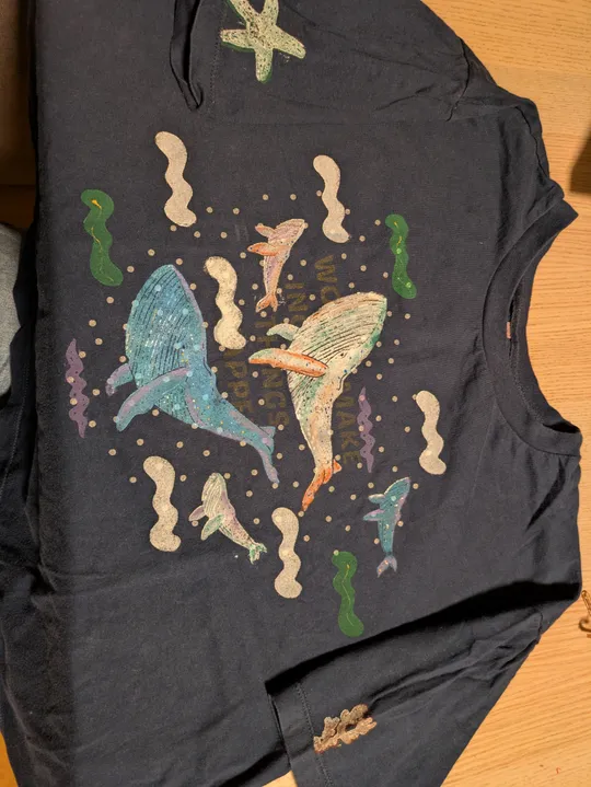 T-shirt with ocean animal illustrations on wood.