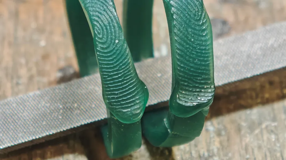 Green wax rings on a wooden surface.