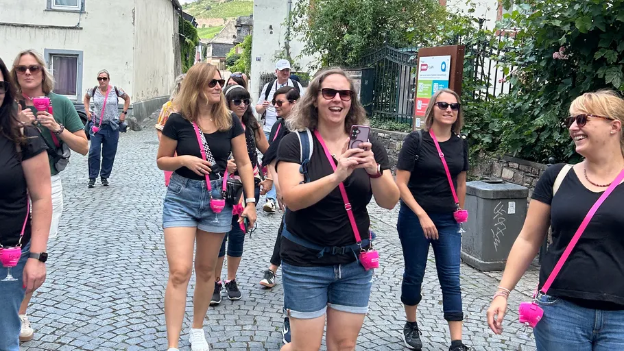 Group of women walking on cobblestone street.