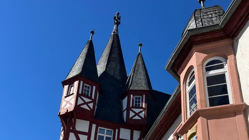 Towers of a traditional building against blue sky.