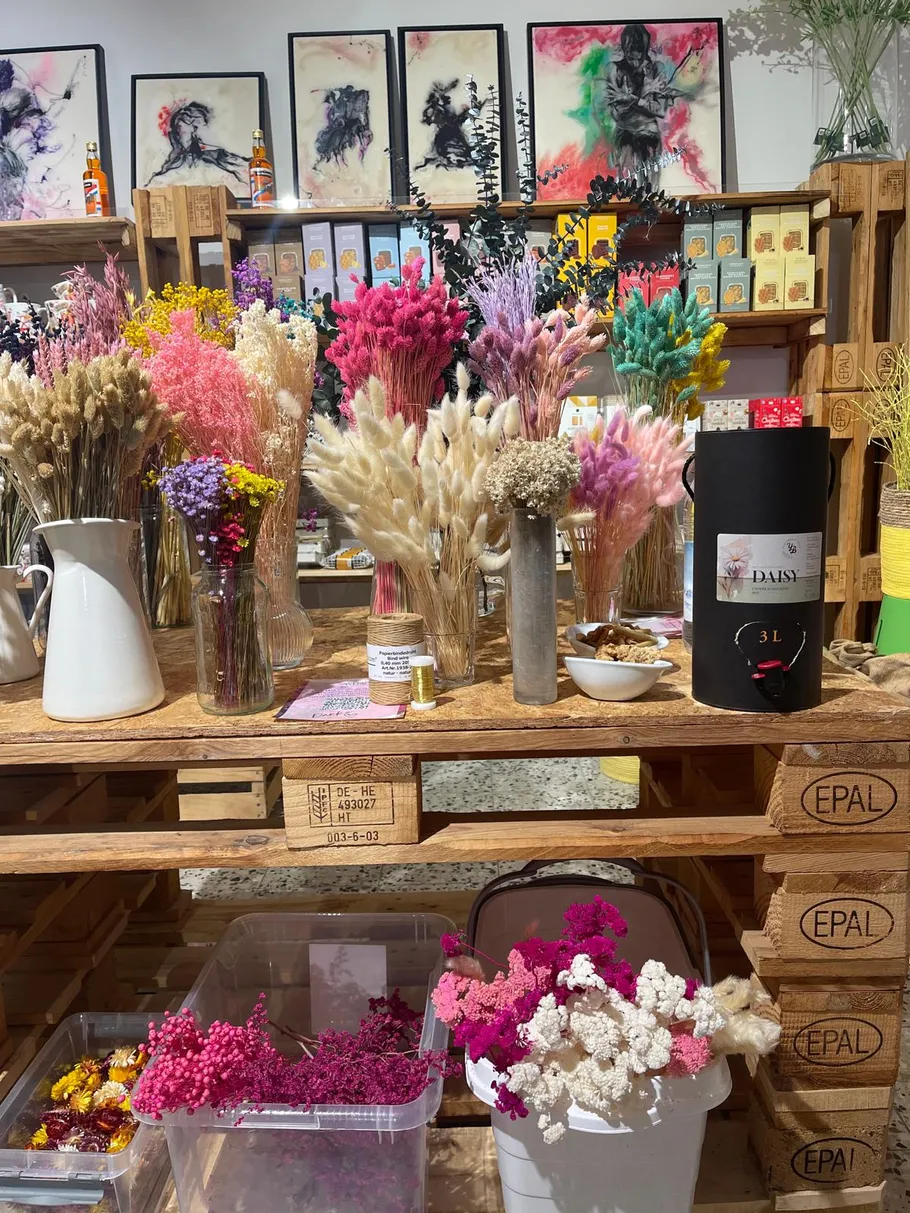 Dried flowers displayed on a wooden table.