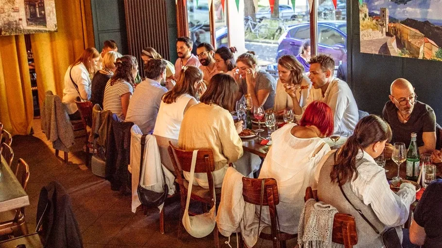 Group dining at a long table in a restaurant.