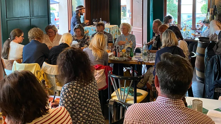 Group of people sitting inside a café.