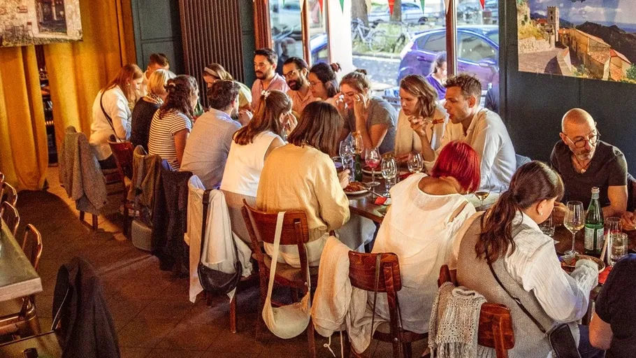 Group dining at a restaurant table indoors.