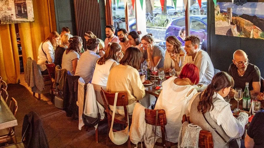 Group dining at a long table in a restaurant.