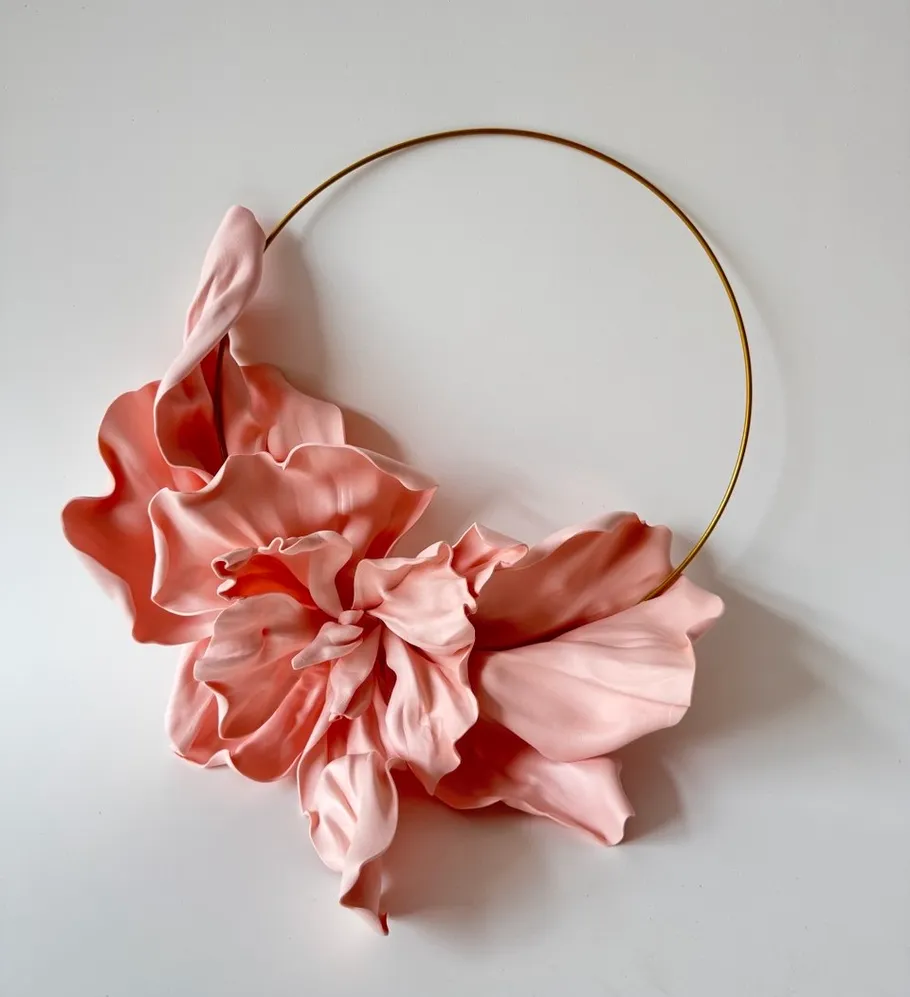 Pink clay flower on a gold wire hoop.