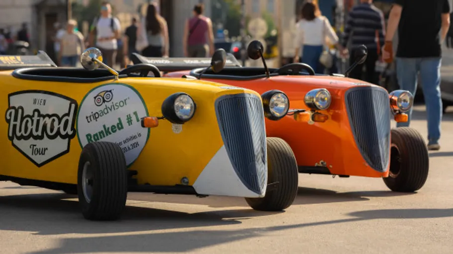 Bright hotrod cars parked on city street.