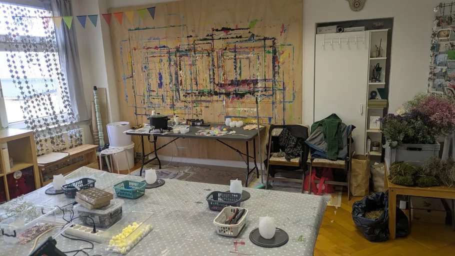 Art studio with table, supplies, and painted wall.