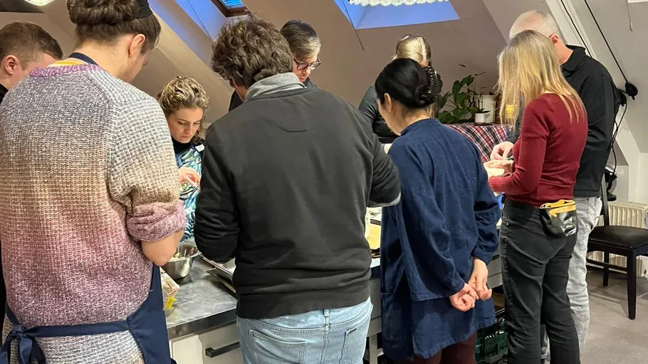 Group cooking together in a kitchen.