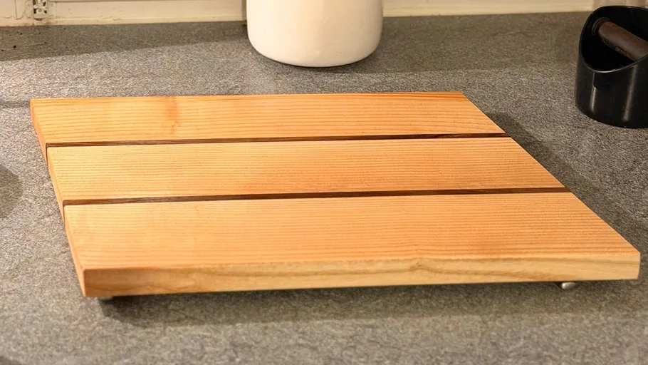 Wooden chopping board on kitchen counter.