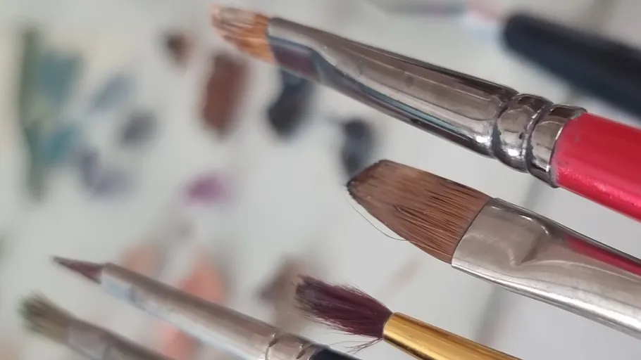 Paintbrushes with colorful blurred background.