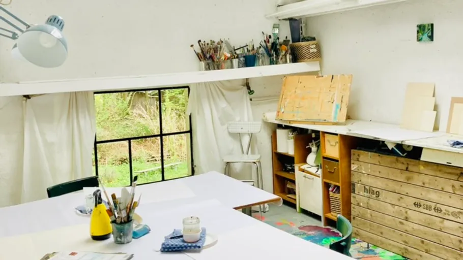Art studio with supplies and worktables.