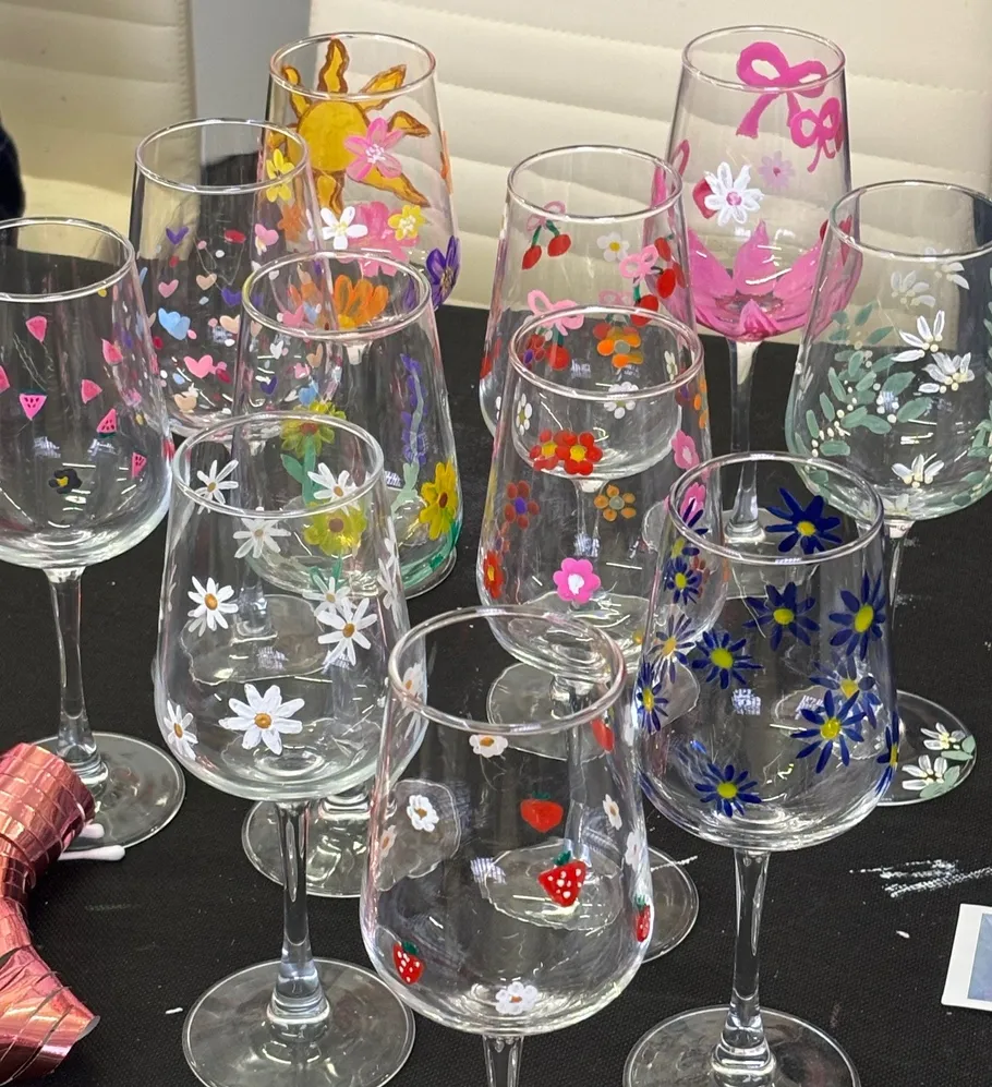 Colorful painted wine glasses on a table.