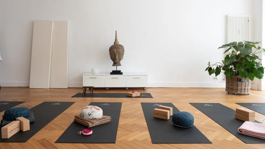 Yoga studio with mats, cushions, and decor.