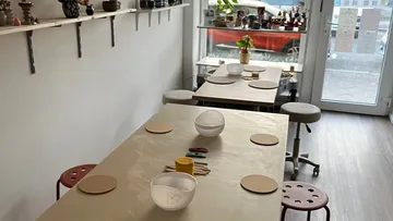 Tables set up for pottery class in studio.