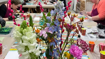 Colorful flowers on table in art class.