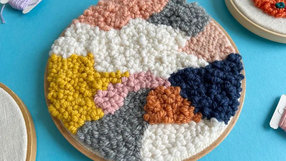 Stickerei-Kunst auf blauem Hintergrund mit Garn.