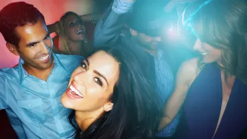 Group of people dancing in a club.