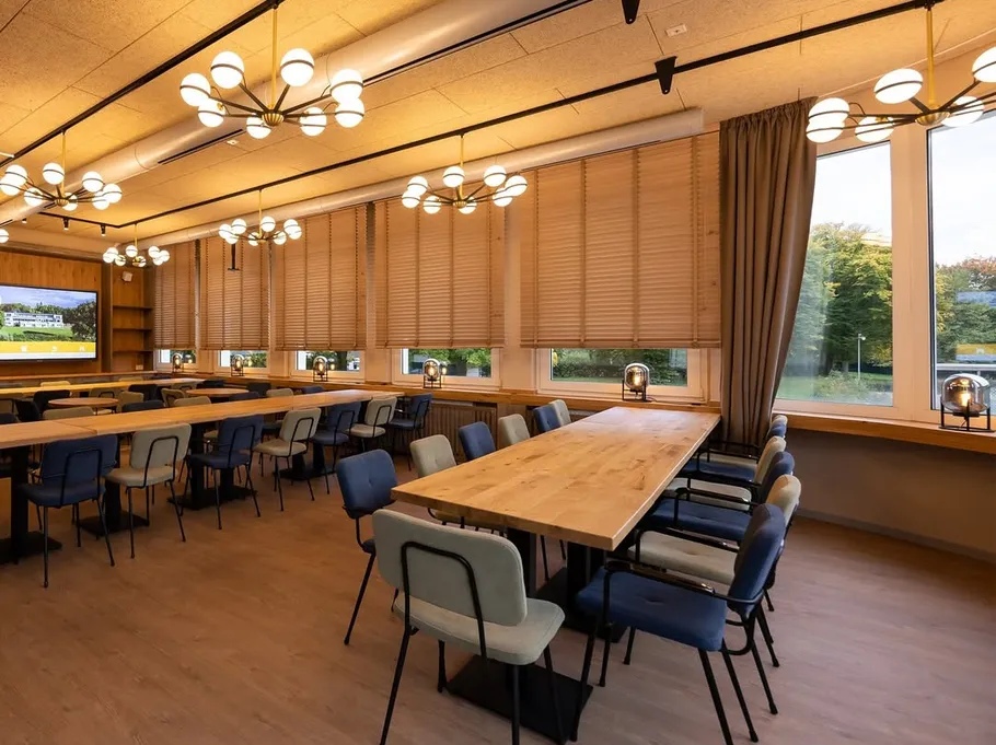 Modern dining area with wooden tables and chairs.